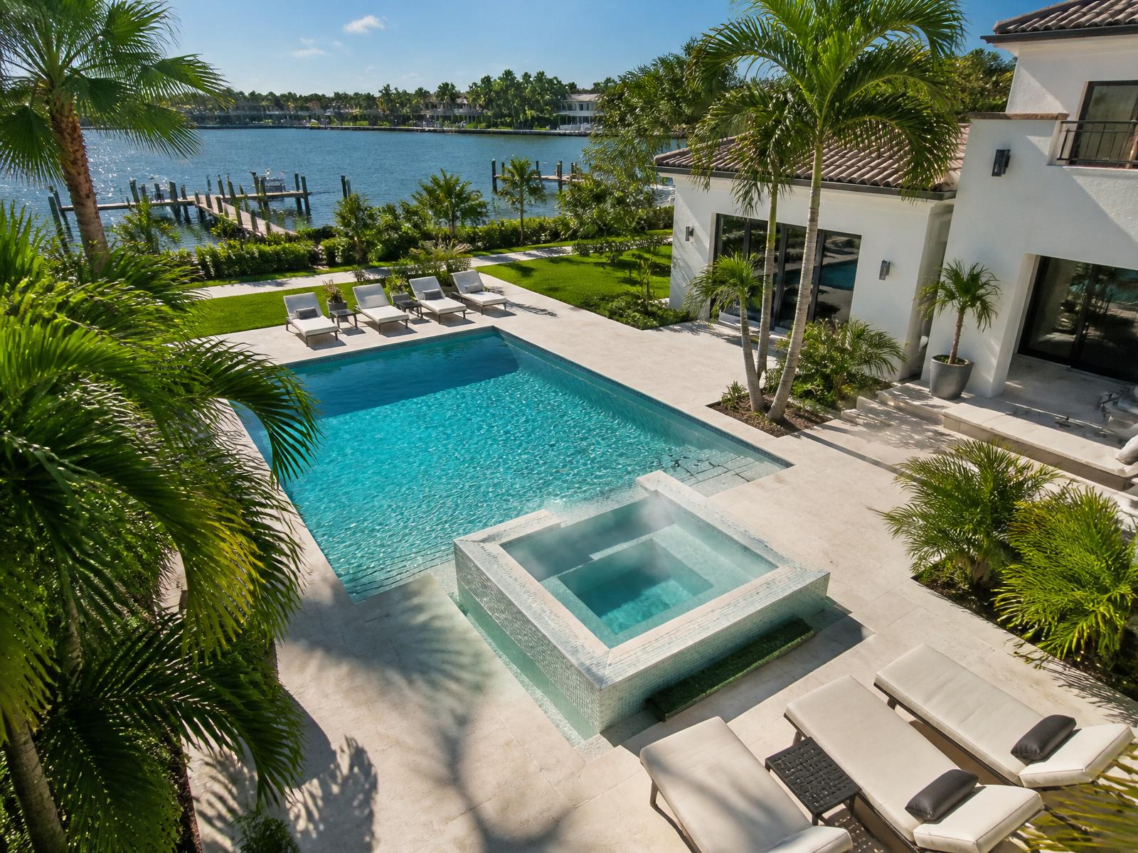 Turquoise heated pool and hot tub with palm trees